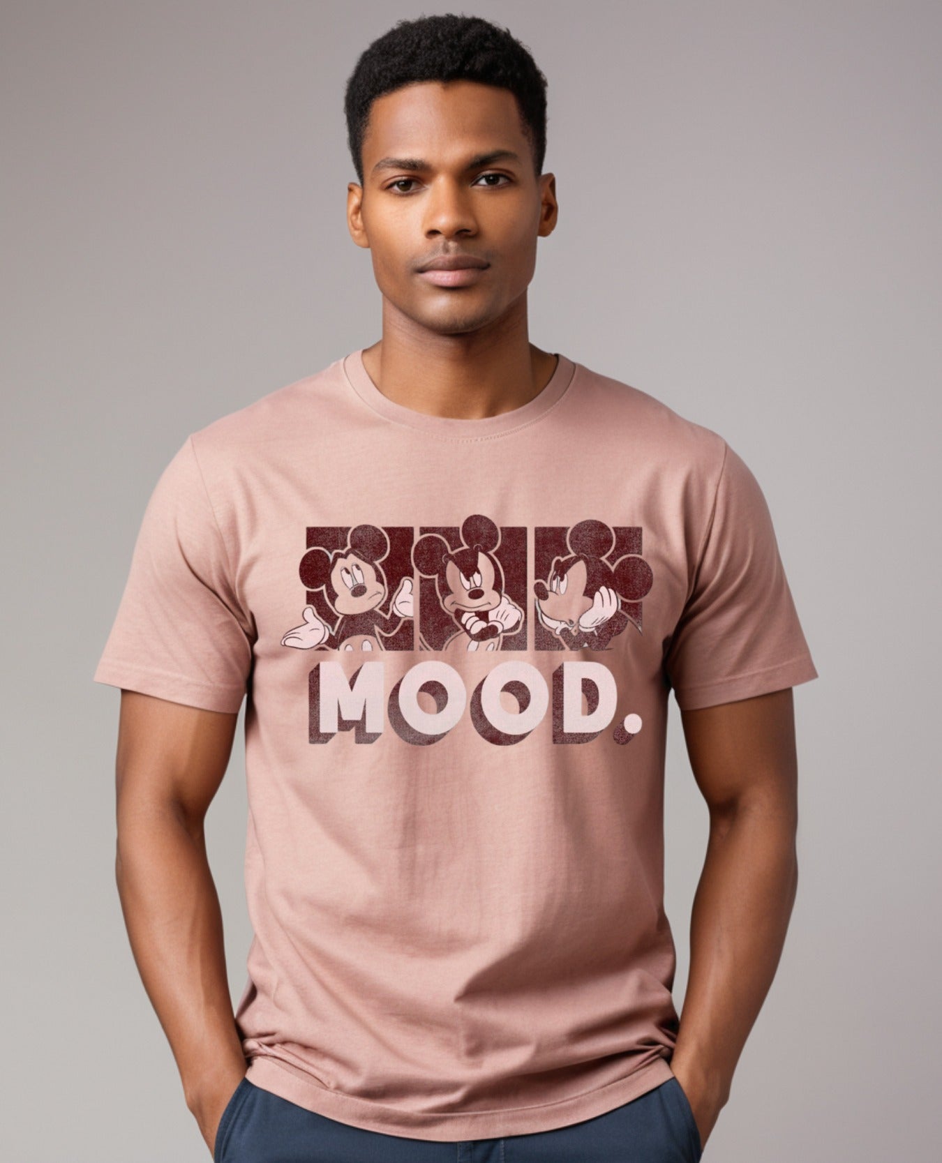 Man wearing Mickey Mouse Mood Graphic Printed Tshirt in pink, made from 100% premium cotton for casual style and comfort.